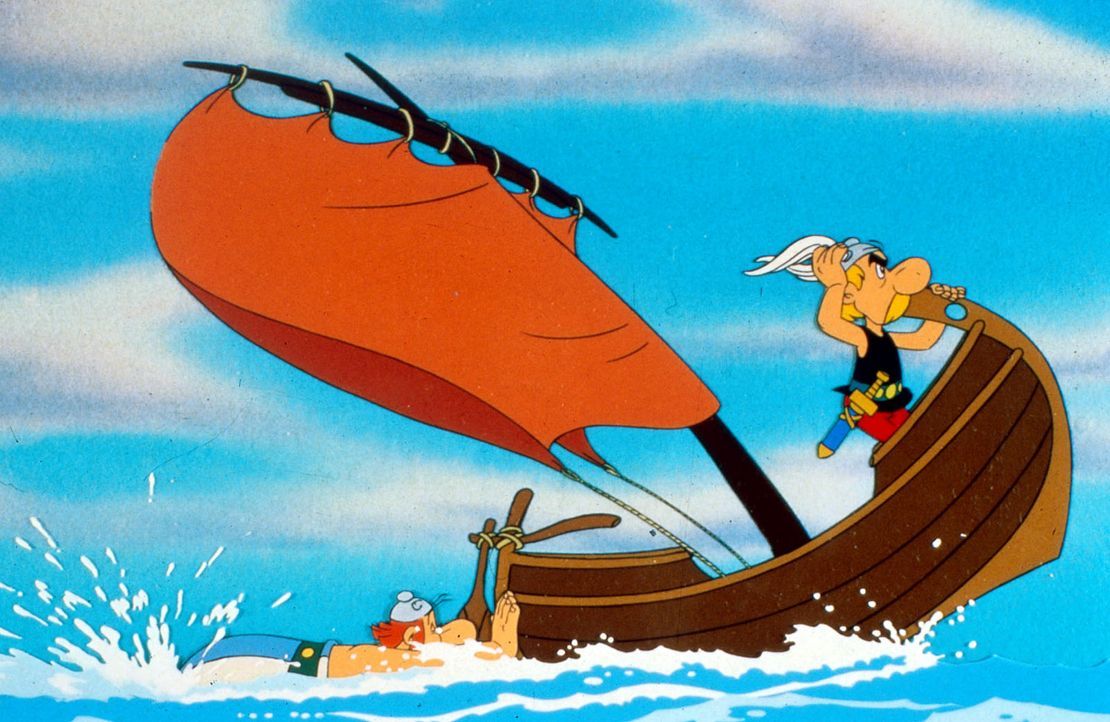 Obelix (l.) betätigt sich als Außenbordmotor, während Asterix (r.) den  Kurs vorgibt - nach Amerika. Sie verfolgen Miraculix, der von den Römern... - Bildquelle: Jugendfilm-Verleih GmbH